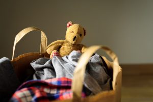 Image of a teddy bear in a donation pile 